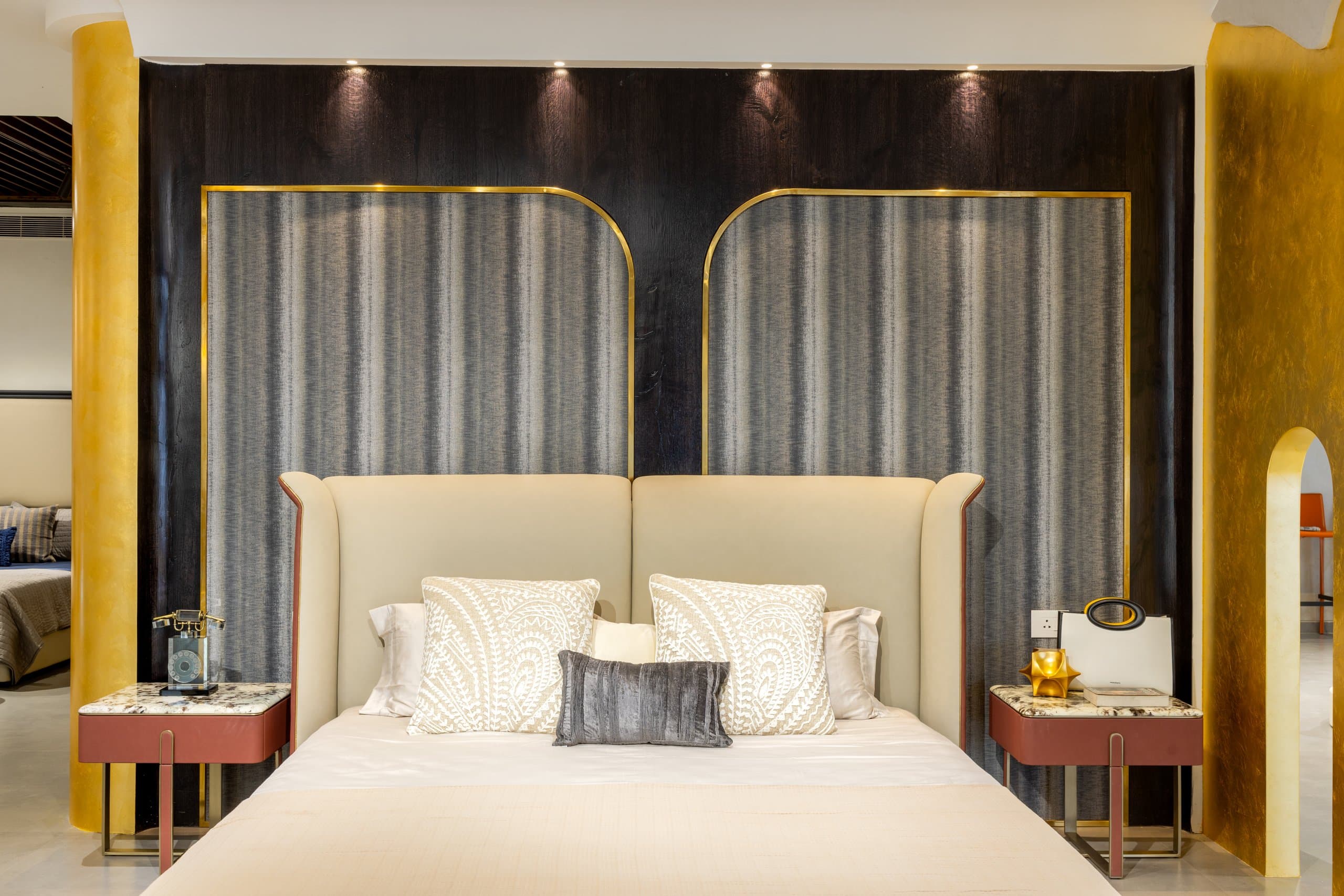 Bedside styled at hand scale against an upholstered wall.