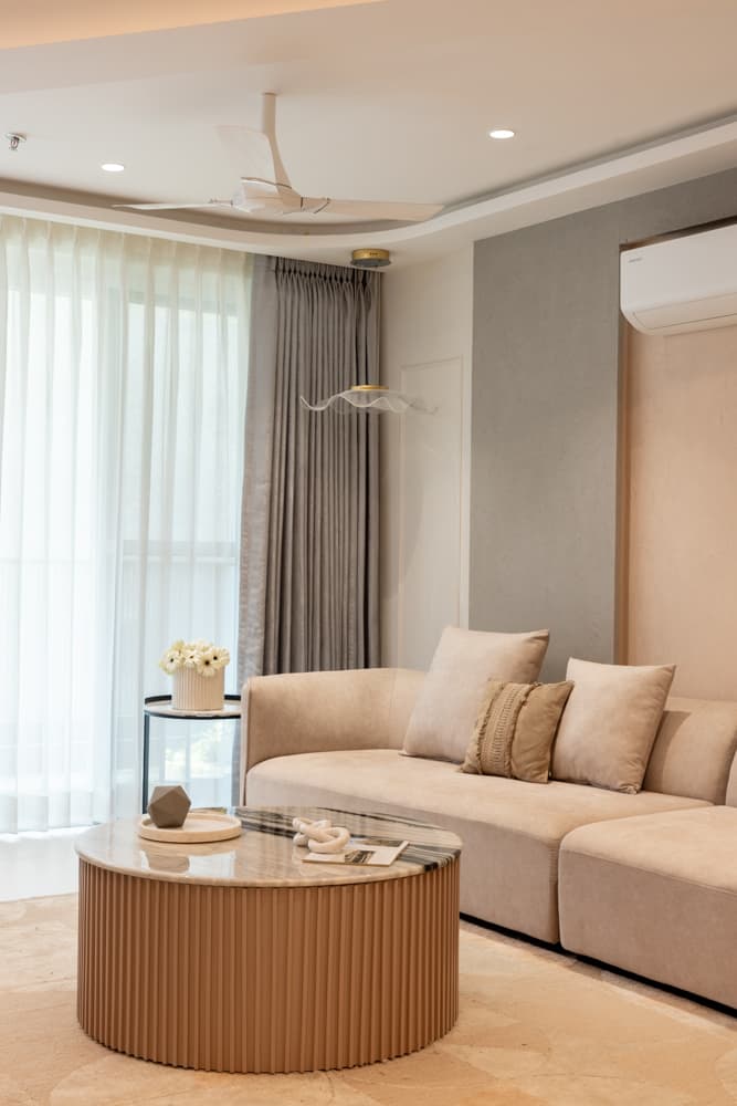 A wide view of the living room, styled for the long sightline.